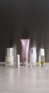 Winter skincare essentials next to each other on grey table top with mood lighting 